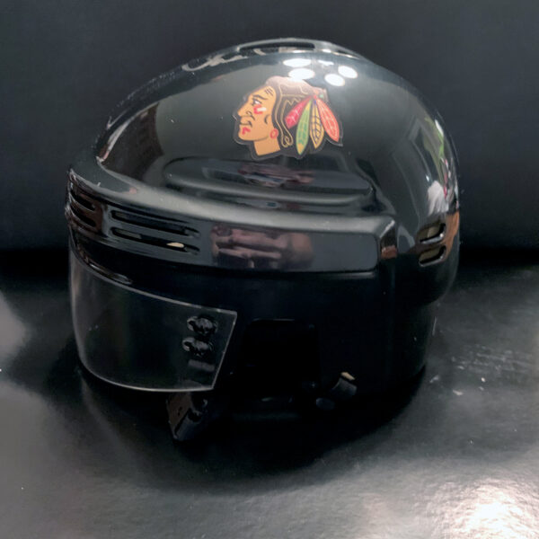 Side View of Black Blackhawks Mini-Helmet signed by Chris Chelios
