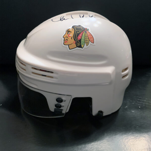 Side View of a White Blackhawks Mini-Helmet signed by Chris Chelios